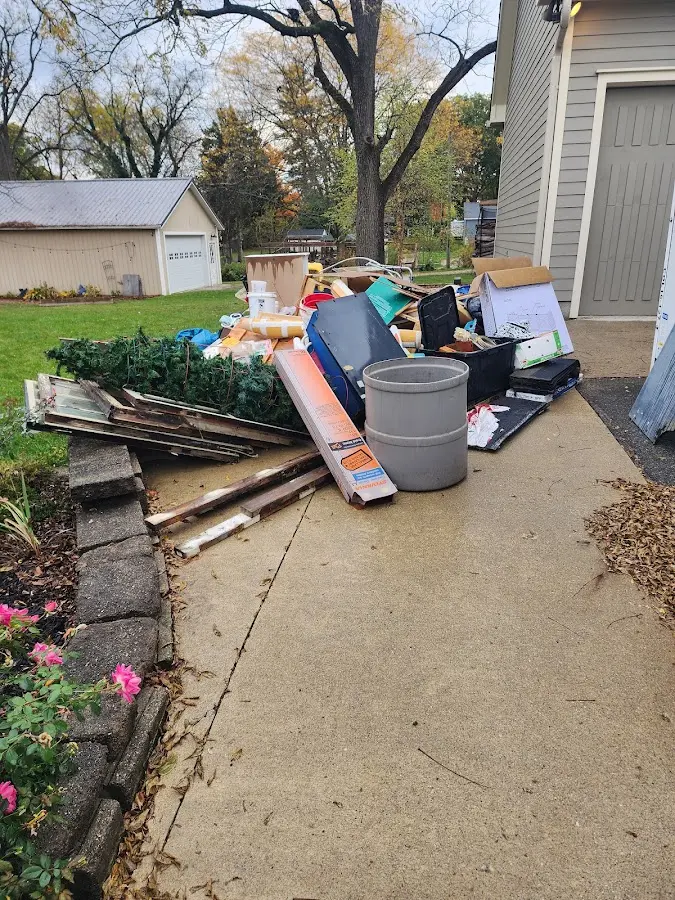 Dumpster being loaded with debris for Roofing Dumpster Rental in Skidaway Island